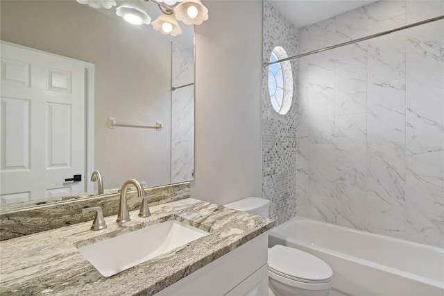 full bathroom with tiled shower / bath combo, toilet, and vanity