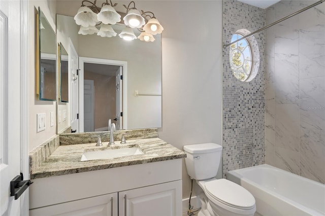 full bathroom featuring vanity, toilet, and tiled shower / bath combo