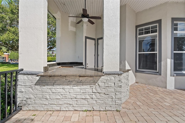 view of patio featuring an outdoor bar and ceiling fan