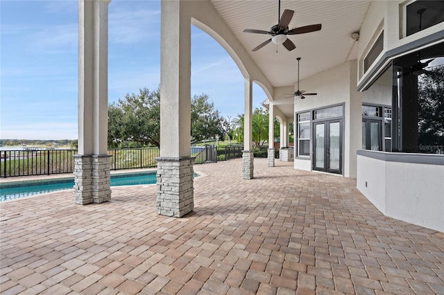 view of patio / terrace featuring french doors, a fenced in pool, and ceiling fan