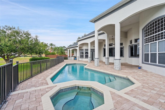 view of swimming pool with an in ground hot tub and a patio