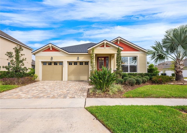 view of front of home with a front yard and a garage