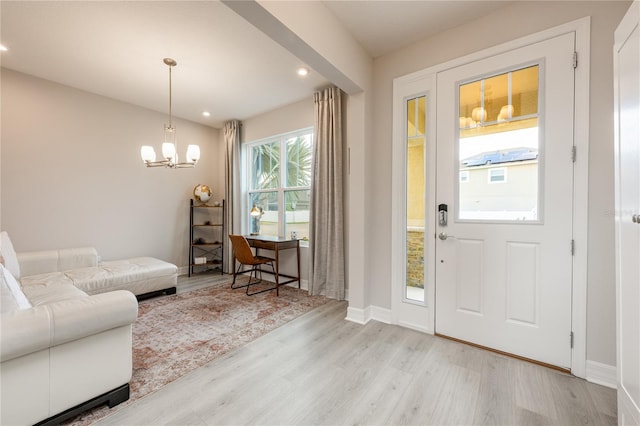 foyer featuring a notable chandelier and light hardwood / wood-style flooring