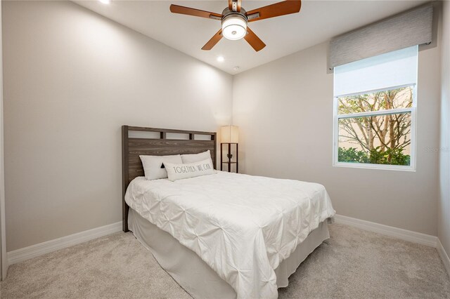 bedroom with ceiling fan and light carpet