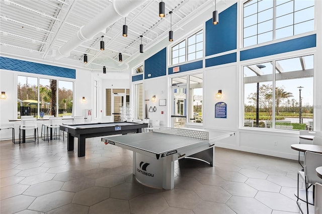 playroom with tile patterned flooring, a towering ceiling, and pool table