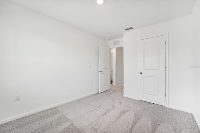 unfurnished bedroom featuring light carpet