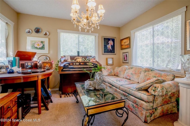 living room with light carpet and a chandelier