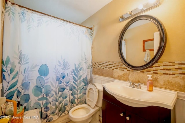 bathroom featuring a shower with curtain, vanity, tile walls, and toilet