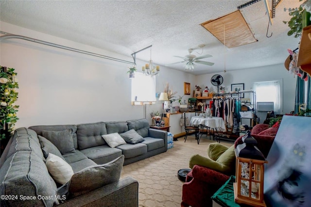 living room featuring light carpet, ceiling fan, and a textured ceiling