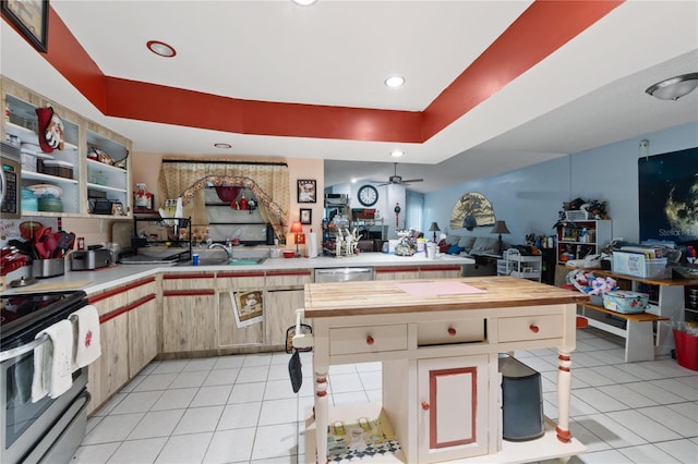 kitchen featuring wooden counters, appliances with stainless steel finishes, ceiling fan, sink, and light tile patterned floors