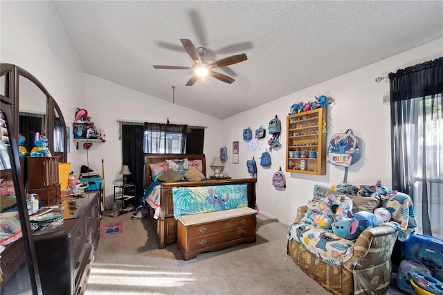 bedroom featuring a textured ceiling, light colored carpet, ceiling fan, and lofted ceiling