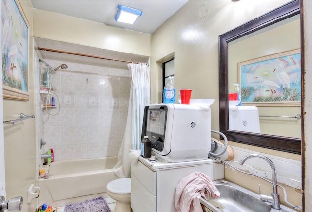 full bathroom featuring sink, tile patterned floors, shower / bath combination with curtain, washer / dryer, and toilet