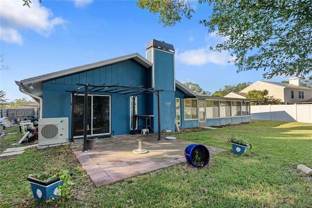 back of property with a pergola, ac unit, a patio area, a sunroom, and a lawn