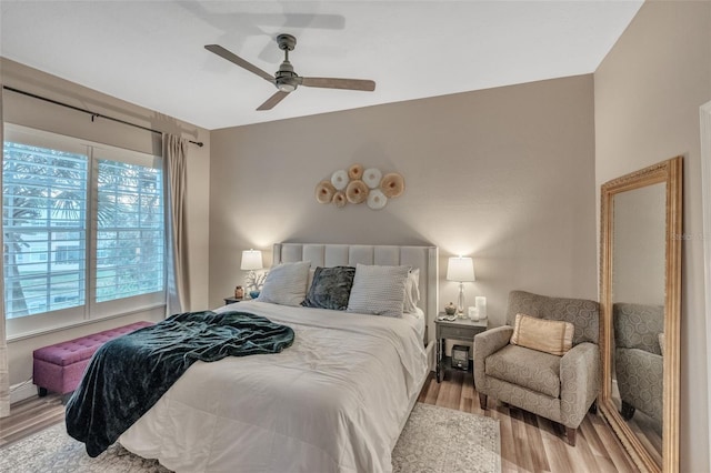 bedroom with ceiling fan and light wood-type flooring