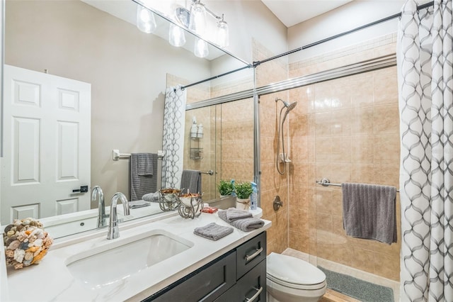 bathroom with vanity, toilet, and curtained shower