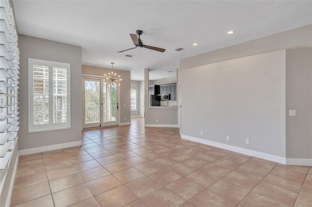 unfurnished living room with light tile patterned floors, baseboards, recessed lighting, and ceiling fan with notable chandelier