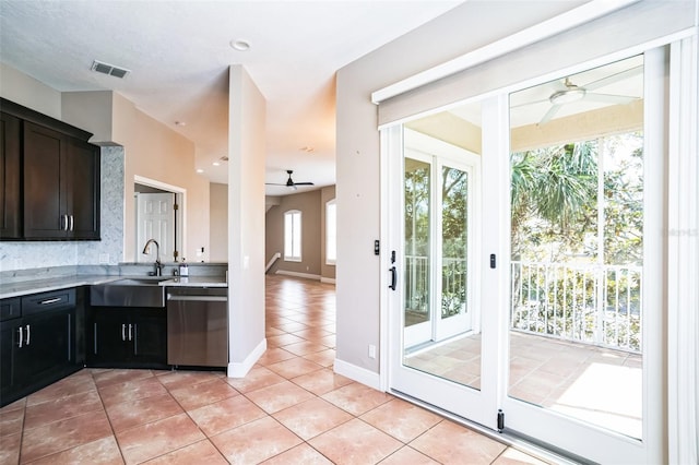 kitchen featuring visible vents, ceiling fan, stainless steel dishwasher, light tile patterned flooring, and a sink