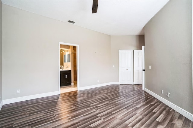 interior space featuring visible vents, wood finished floors, baseboards, and ceiling fan