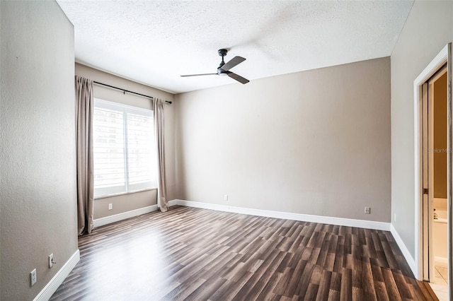 empty room featuring baseboards, a textured ceiling, wood finished floors, and a ceiling fan