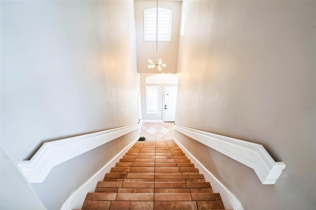 7700 Carriage Homes Dr Unit 4, Orlando, FL 32819 - staircase with baseboards and a chandelier