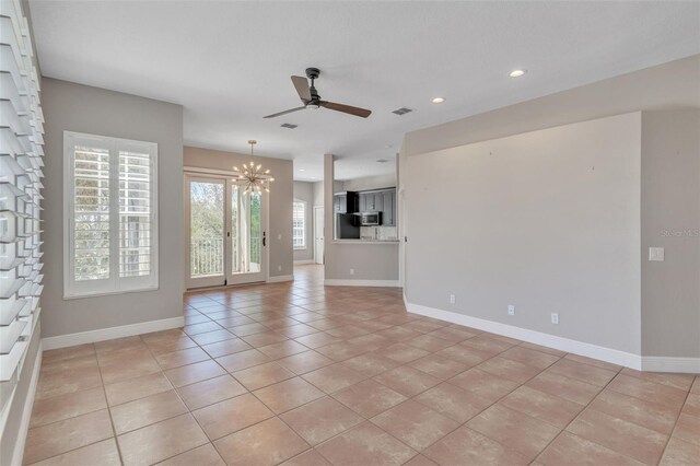 7700 Carriage Homes Dr Unit 4, Orlando, FL 32819 - unfurnished living room with light tile patterned floors, baseboards, and ceiling fan with notable chandelier