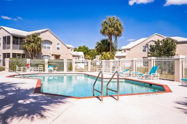 7700 Carriage Homes Dr Unit 4, Orlando, FL 32819 - community pool with a patio area, fence, and a residential view