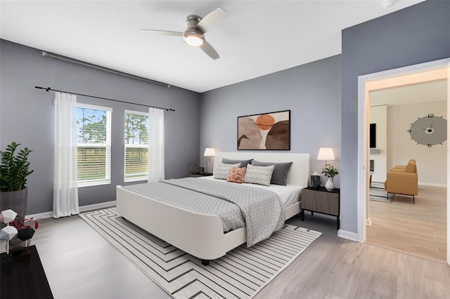 bedroom with ceiling fan and light hardwood / wood-style flooring