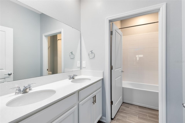 full bathroom featuring hardwood / wood-style floors, vanity, toilet, and shower / washtub combination