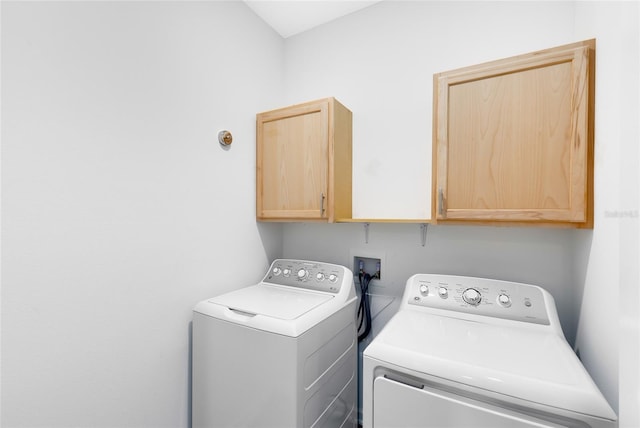 laundry room with cabinets and washing machine and clothes dryer