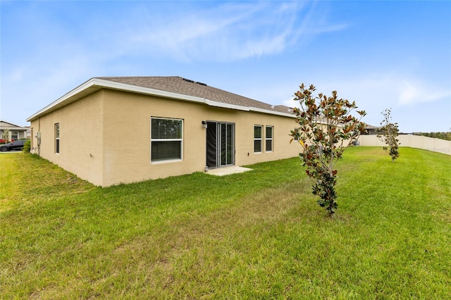 rear view of house with a yard