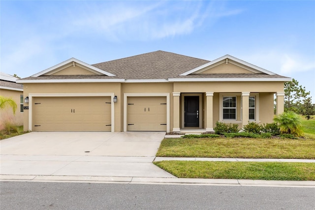 view of front of home with a front lawn, a porch, and a garage