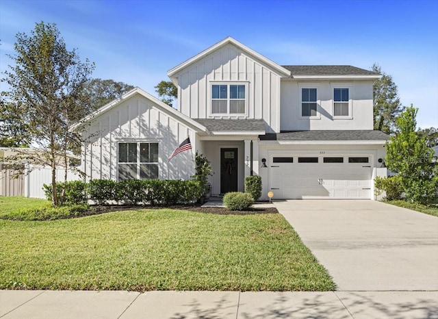 view of front of house with a garage and a front lawn