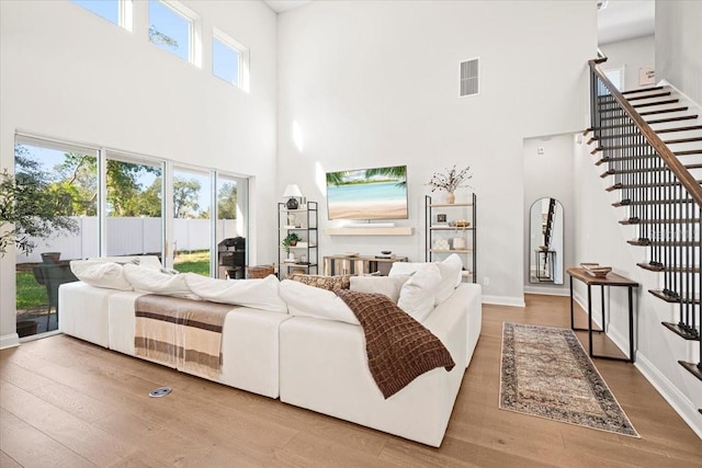 bedroom featuring a high ceiling and hardwood / wood-style flooring