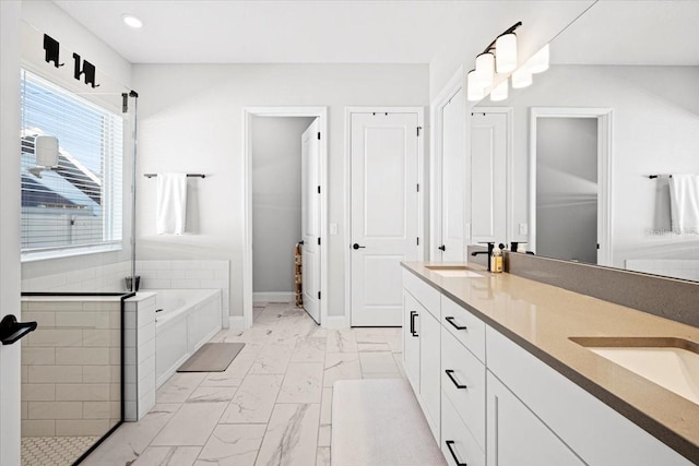 bathroom with vanity and separate shower and tub