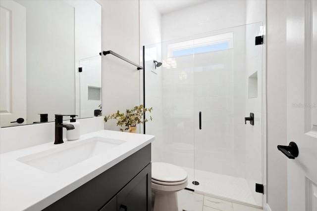 bathroom with vanity, toilet, and a shower with door