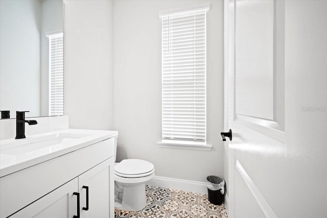 bathroom with tile patterned floors, vanity, and toilet