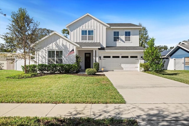 view of front of home with a front yard and a garage