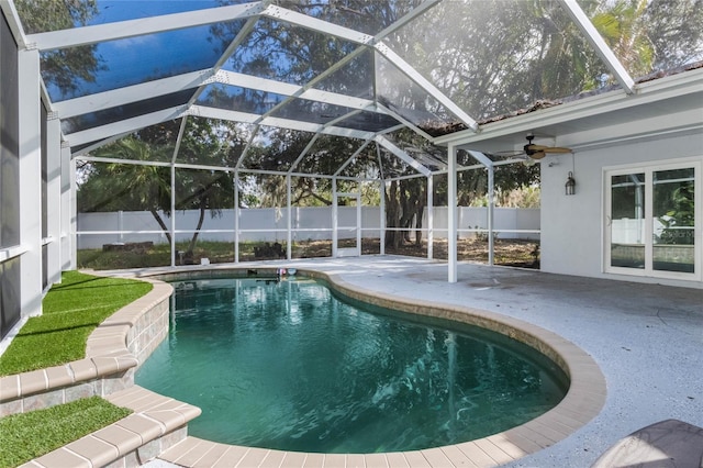 view of pool with a lanai, ceiling fan, and a patio area