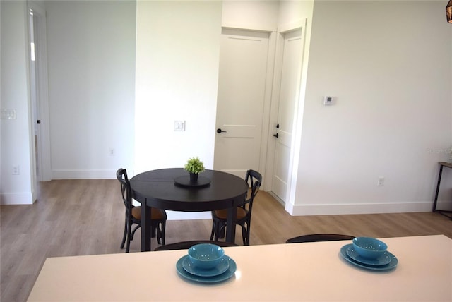 dining space featuring light hardwood / wood-style floors