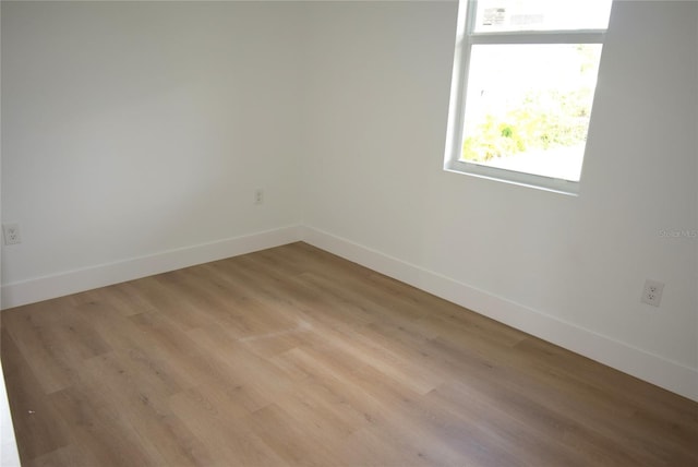 unfurnished room with light wood-type flooring