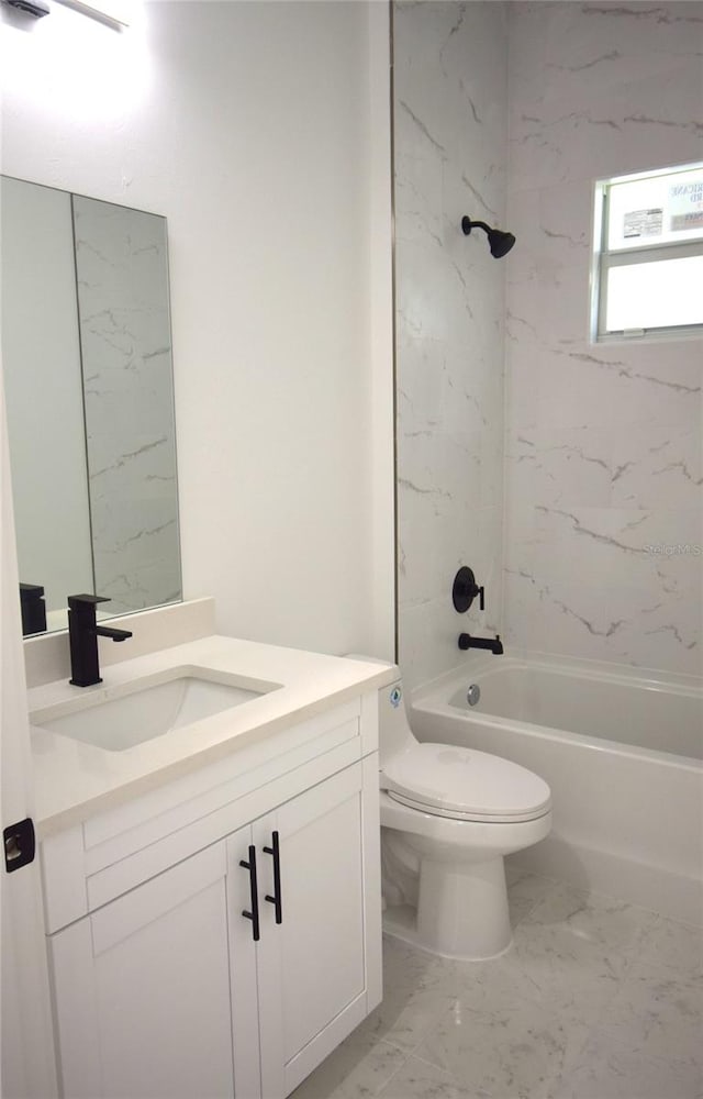 full bathroom featuring vanity, toilet, and tiled shower / bath