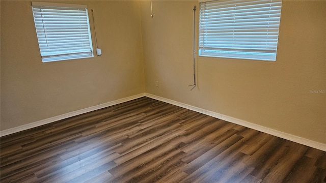 spare room featuring dark hardwood / wood-style floors