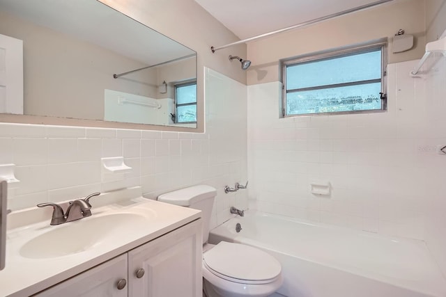 full bathroom featuring tile walls, vanity, plenty of natural light, and toilet