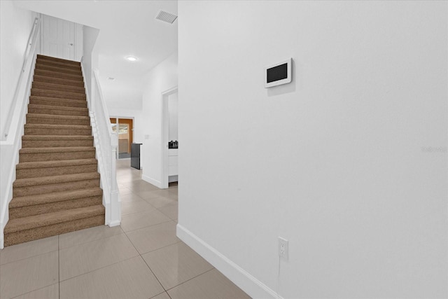 corridor featuring light tile patterned floors