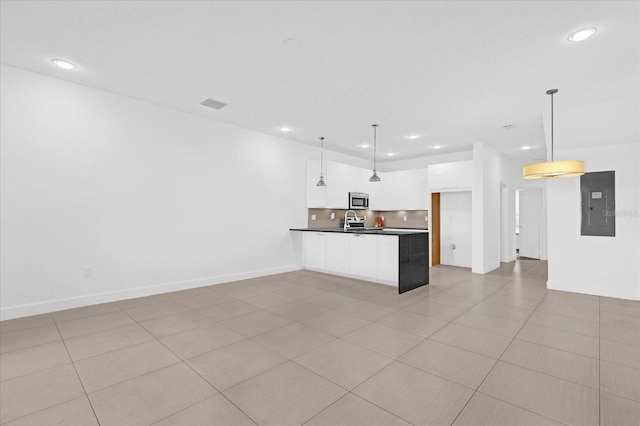 kitchen featuring electric panel, white cabinetry, hanging light fixtures, and light tile patterned flooring