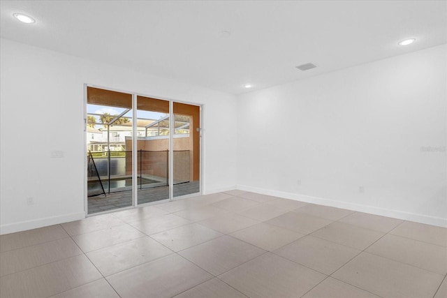 spare room featuring light tile patterned floors