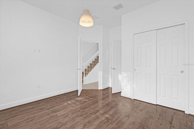 interior space featuring dark wood-type flooring and a closet