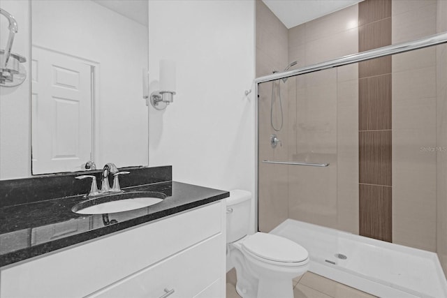 bathroom with tile patterned flooring, vanity, toilet, and a shower with door