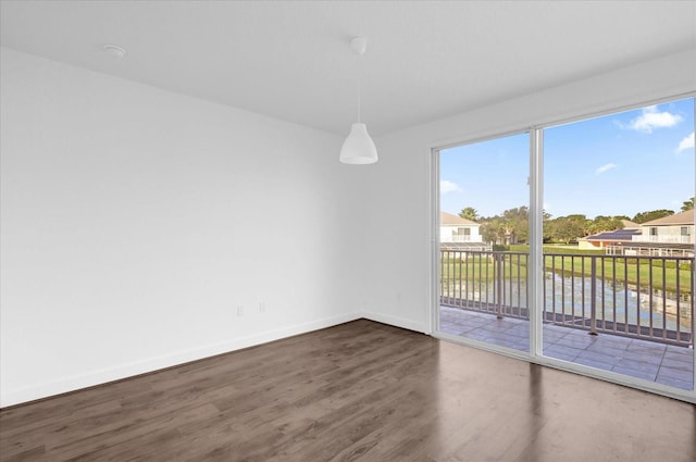 empty room with a water view and hardwood / wood-style flooring