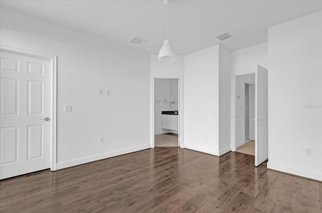 spare room featuring dark wood-type flooring